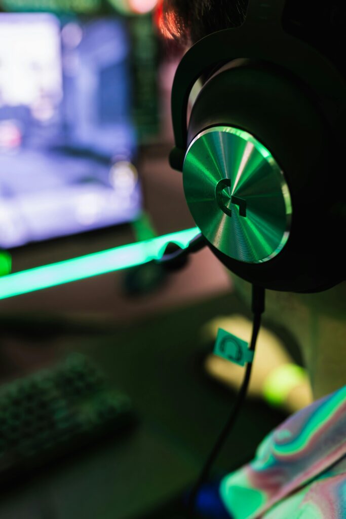 Engaging gaming session with pro headset in dynamic lighting environment.